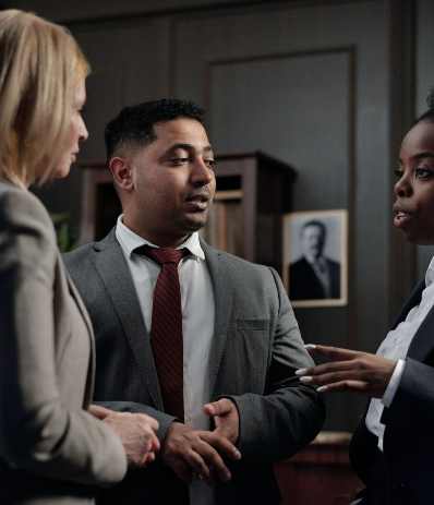 A couple discussing a matter with a woman lawyer in a professional setting.